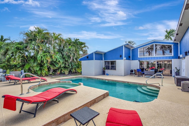 view of swimming pool with an in ground hot tub and a patio