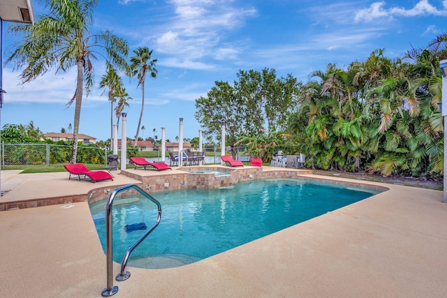 view of pool featuring an in ground hot tub and a patio