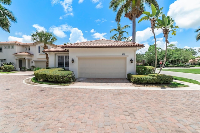 mediterranean / spanish home with a garage