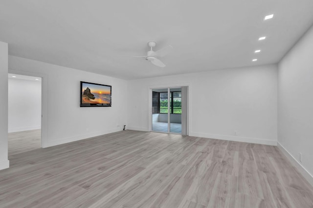 empty room with light wood-type flooring and ceiling fan