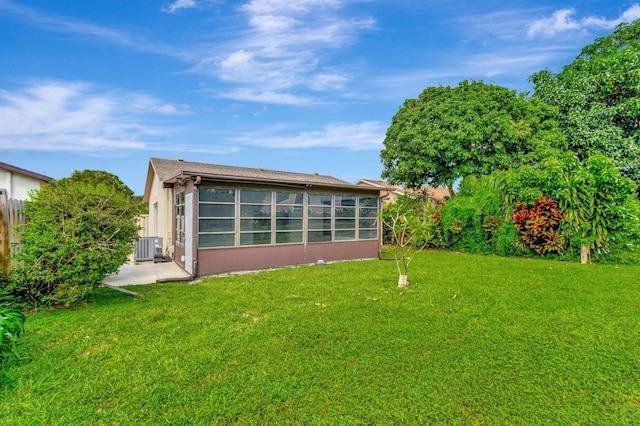 rear view of house featuring a patio area, cooling unit, and a yard