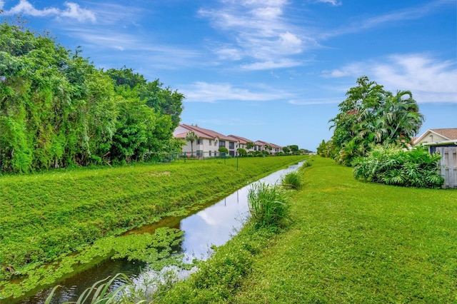 exterior space featuring a water view and a lawn