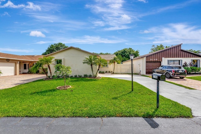 ranch-style home with a front lawn and a garage