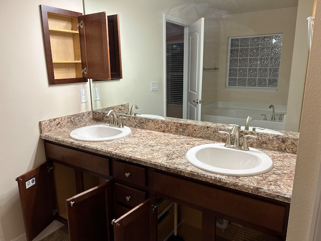 bathroom with vanity and a bath