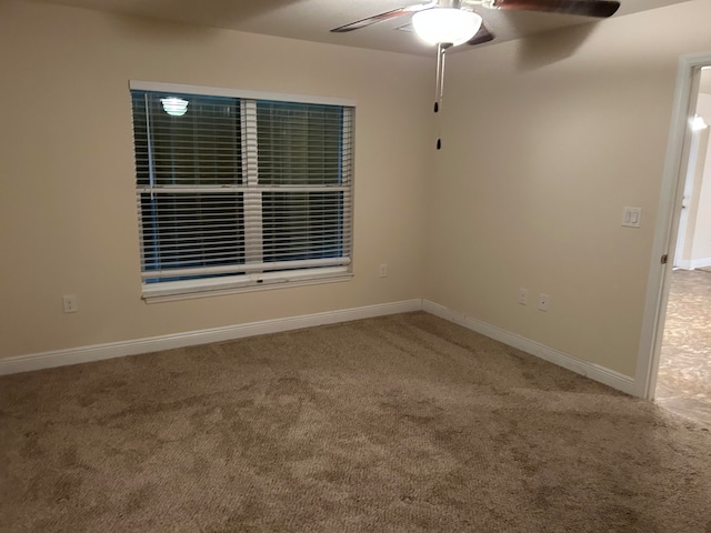 spare room featuring ceiling fan and carpet floors