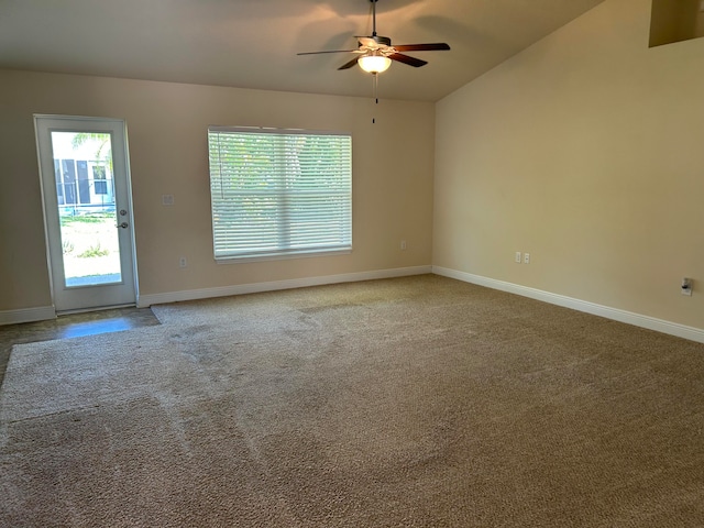 carpeted empty room featuring ceiling fan and vaulted ceiling