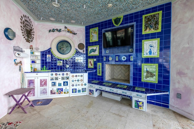 interior space featuring tile walls and ornamental molding