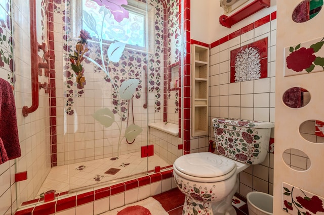 bathroom featuring toilet, tile walls, and a tile shower