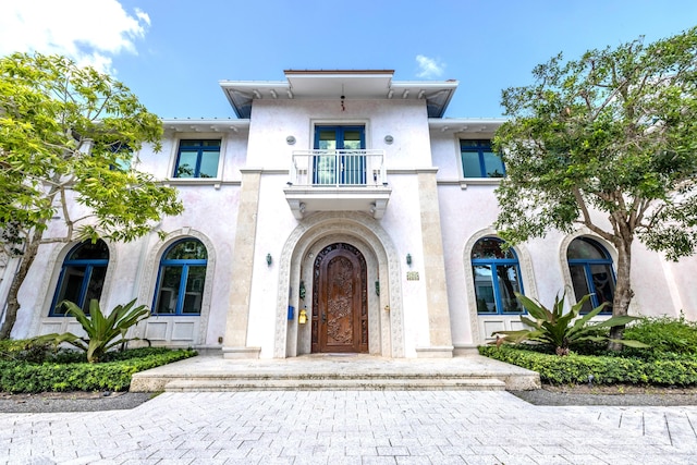 view of front of home featuring french doors and a balcony