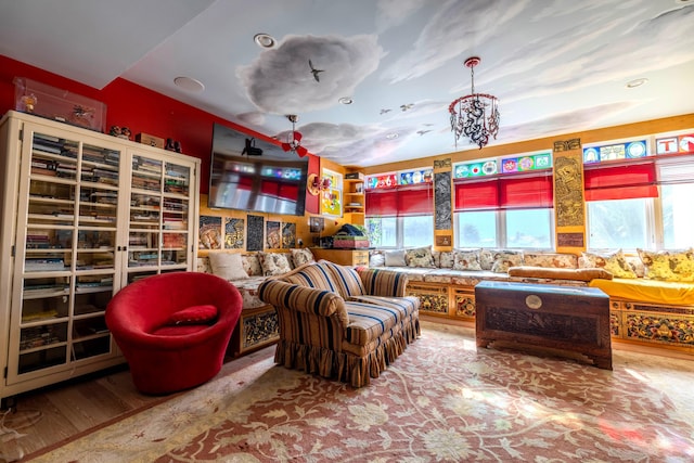 sitting room with wood-type flooring and a chandelier