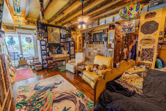 interior space featuring beamed ceiling, hardwood / wood-style flooring, and ceiling fan