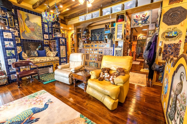 sitting room featuring wood-type flooring and beam ceiling