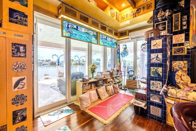 sunroom / solarium featuring an AC wall unit