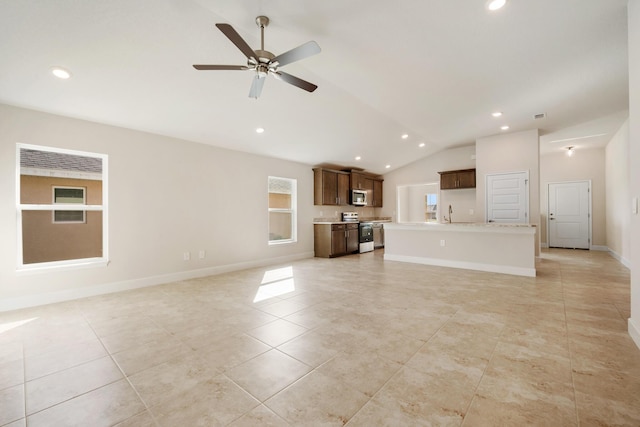 5215 San Benedetto Pl, Fort Pierce, FL 34951 - unfurnished living room with vaulted ceiling, light tile patterned floors, a ceiling fan, recessed lighting, and baseboards