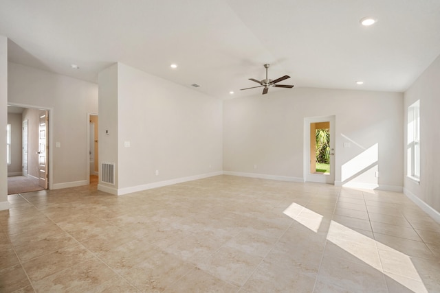 unfurnished room featuring ceiling fan, plenty of natural light, light tile patterned floors, and vaulted ceiling