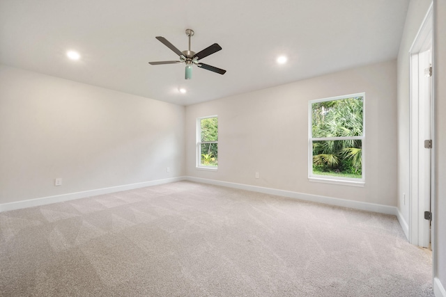 carpeted spare room with ceiling fan