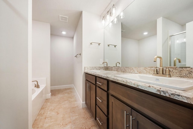 5215 San Benedetto Pl, Fort Pierce, FL 34951 - bathroom featuring double vanity, a garden tub, a shower stall, tile patterned floors, and baseboards
