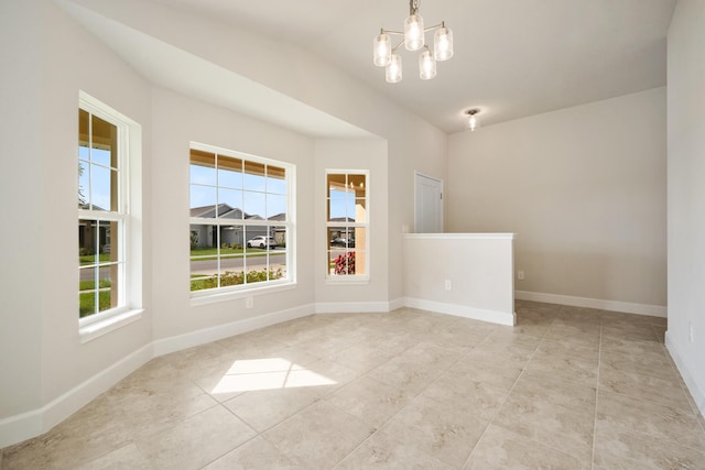 5215 San Benedetto Pl, Fort Pierce, FL 34951 - tiled spare room with a chandelier, baseboards, and vaulted ceiling