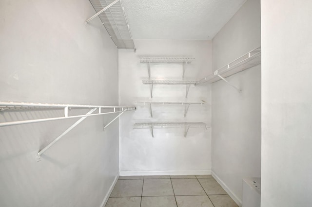 walk in closet featuring light tile patterned flooring