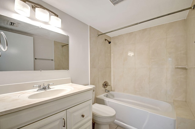 full bathroom with vanity, tiled shower / bath combo, toilet, and tile patterned flooring