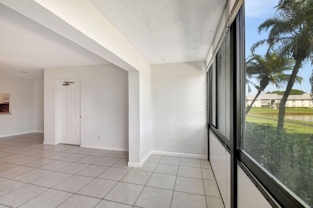 tiled spare room featuring a textured ceiling