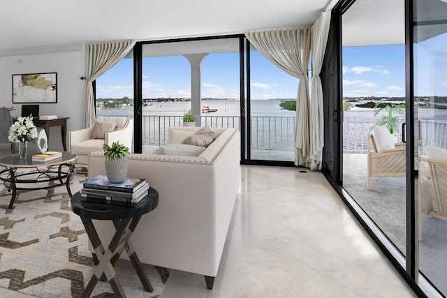 living room with expansive windows and a water view