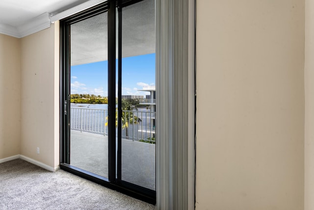 doorway to outside featuring light carpet, a water view, a wealth of natural light, and ornamental molding