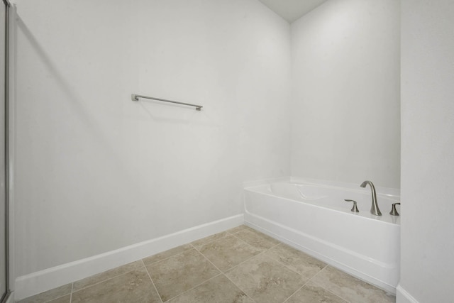 bathroom featuring a bathing tub and tile patterned flooring