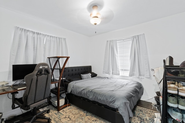 bedroom with hardwood / wood-style floors and ceiling fan