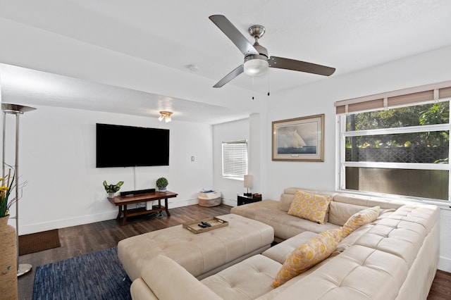 living room with dark wood-type flooring and ceiling fan