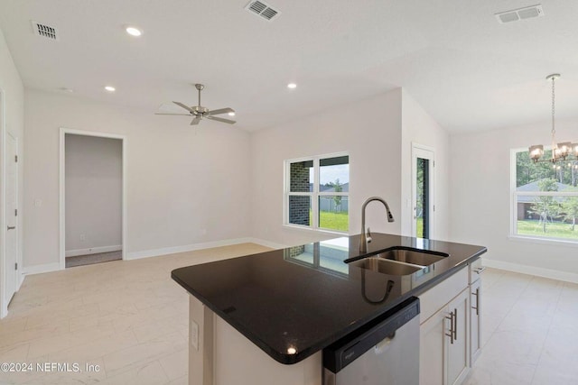 kitchen with a center island with sink, stainless steel dishwasher, a wealth of natural light, and white cabinetry