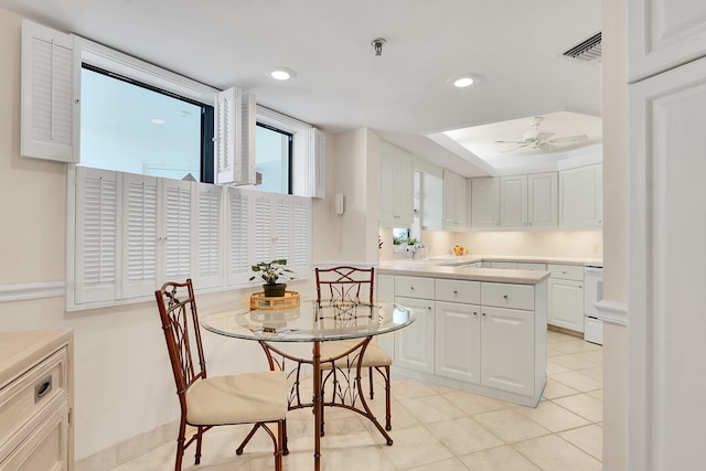 kitchen featuring ceiling fan, sink, light tile patterned flooring, white range, and white cabinets