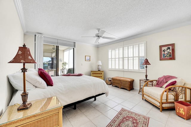 tiled bedroom with ceiling fan, a textured ceiling, and ornamental molding