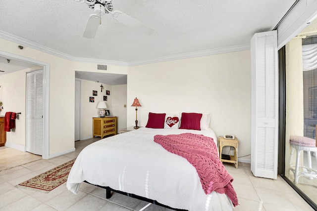 tiled bedroom with ceiling fan, a closet, a textured ceiling, and ornamental molding