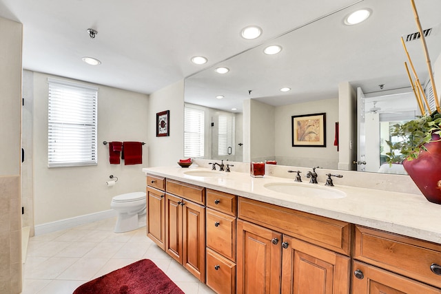 bathroom with tile patterned floors, a shower, vanity, and toilet