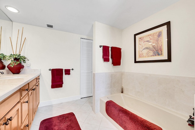 bathroom featuring tile patterned floors, vanity, and a tub