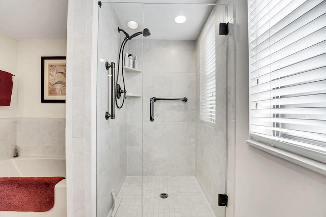 bathroom featuring separate shower and tub and a wealth of natural light