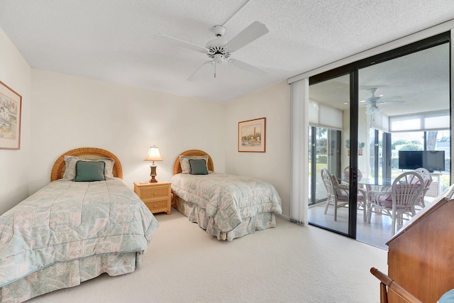 bedroom featuring carpet, floor to ceiling windows, a textured ceiling, access to outside, and ceiling fan