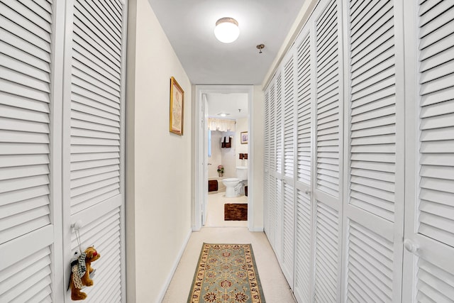 corridor featuring light colored carpet