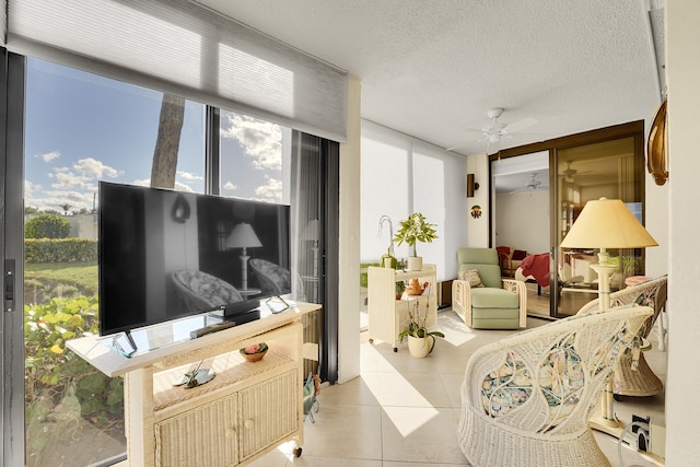 tiled living room with a textured ceiling and expansive windows