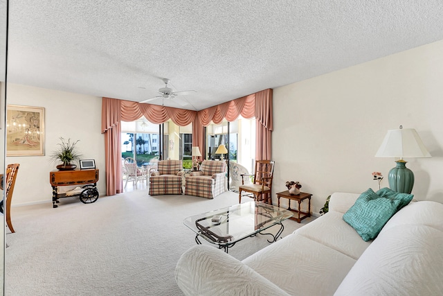 living room with carpet flooring, ceiling fan, and a textured ceiling