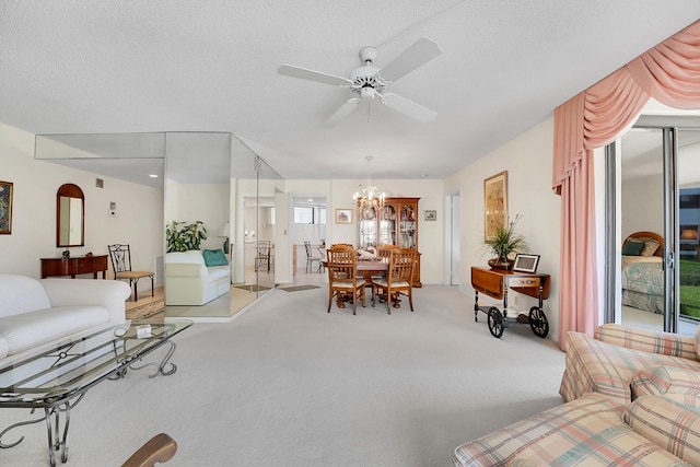 living room with light carpet, ceiling fan with notable chandelier, and a textured ceiling