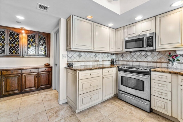 kitchen featuring light tile patterned floors, backsplash, appliances with stainless steel finishes, visible vents, and recessed lighting