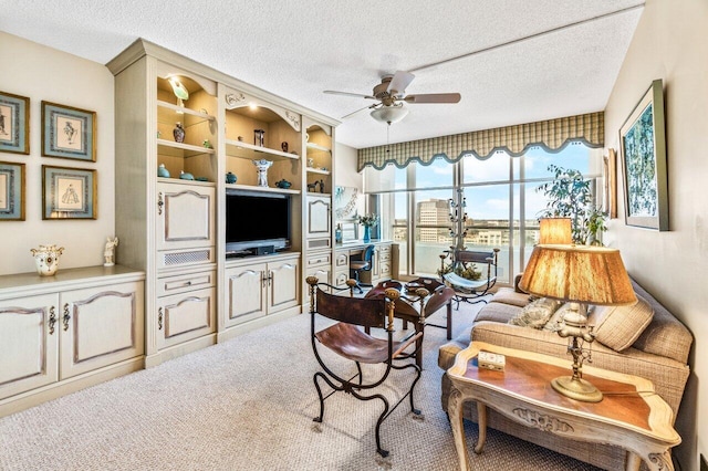 carpeted living room with a textured ceiling and ceiling fan