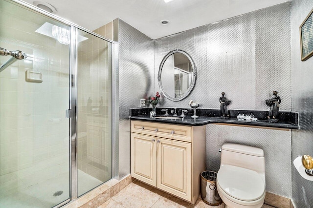 bathroom featuring toilet, a shower with shower door, vanity, and tile patterned floors