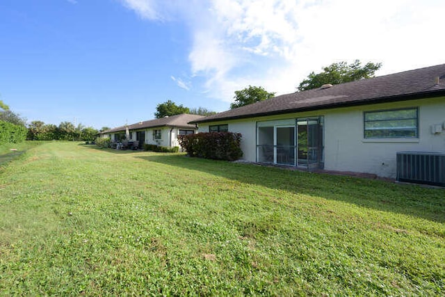 view of yard featuring central air condition unit