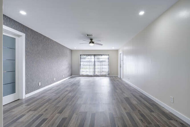 spare room with ceiling fan and dark hardwood / wood-style flooring