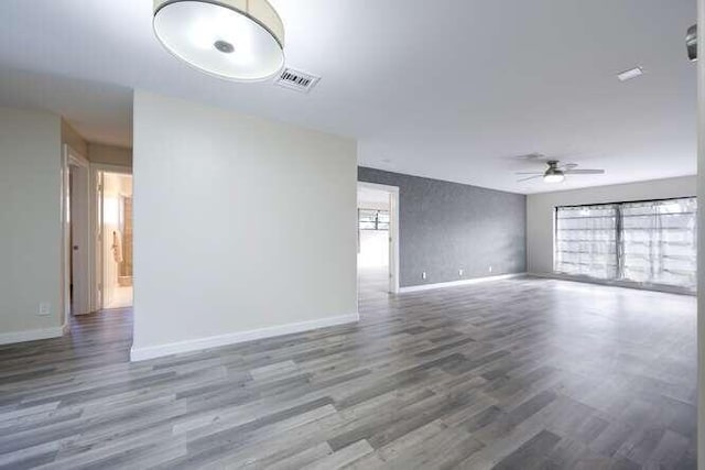 unfurnished room featuring ceiling fan and dark hardwood / wood-style flooring