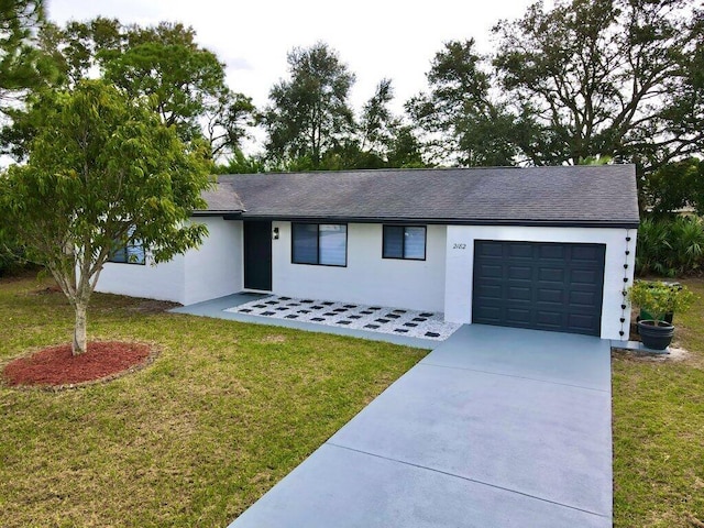 single story home featuring an attached garage, a shingled roof, concrete driveway, stucco siding, and a front lawn