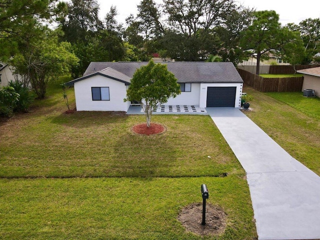 view of front of property featuring an attached garage, driveway, a front yard, and fence